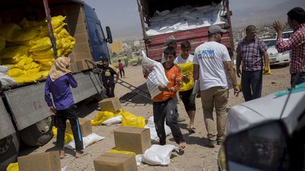 &nbsp; (Distribution de denrées alimentaires à des réfugiés yézidis dans le Nord de l'Irak par Action Contre la Faim © LE CAER VIANNEY/SIPA)