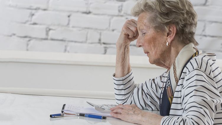 An elderly lady busy with her papers.  ILLUSTRATIVE PHOTO.  (CHASSENET / BSIP / BSIP via AFP)