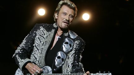 Sous des têtes de mort argentées, Johnny Hallyday chante au festival de poupet, à La Verrie (Vendée), le 22 juillet 2006. (MAXPPP)