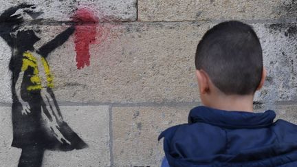 Ce pochoir d'une petite fille en gilet jaune apparue vendredi 15 février à Bordeaux est-elle l'oeuvre de Banksy ? 
 (Mehdi Fedouach / AFP)