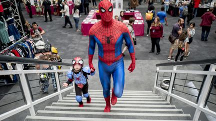 AOUT. Un père et sa fille, le 26 août 2017 à la Super Comic Convention de Londres (Royaume-Uni). (TOLGA AKMEN / AFP)