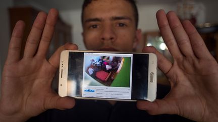 Anass Tahiri, l'un des frères d'Iliass, montre une capture d'écran de la vidéo de la mort de son frère Iliass. (JORGE GUERRERO / AFP)