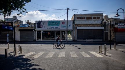 Un homme roule à vélo dans une rue vide à Ashkelon, dans le sud d'Israël, le 13 octobre 2023. Photo d'illustration. (MARTIN DIVISEK / MAXPPP)