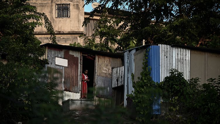 A woman in front of the entrance to the Talus 2 slum in Koungou (Mayotte), May 21, 2023. (PHILIPPE LOPEZ / AFP)