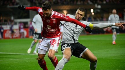 Le Brestois Haris Belkebla (à gauche) et le Parisien Kylian Mbappé (à droite) se sont invectivés sur la pelouse du stade Francis-le-Blé, le 11 mars 2023. (LOIC VENANCE / AFP)