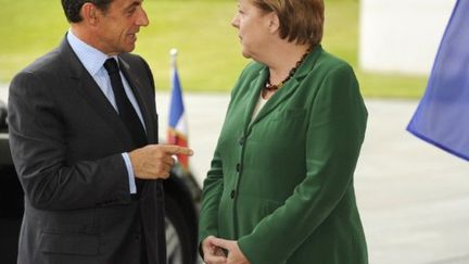 Angela Merkel et Nicolas Sarkozy, le 20 juillet 2011 à Berlin, avant une rencontre préparatoire au sommet le de l'euro. (AFP PHOTO / ODD ANDERSEN)