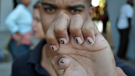 Leoanis, un étudiant en journalisme, montre ses ongles sur lesquels est écrit "Fidel", à Santiago de Cuba (Cuba), lundi 28 novembre 2016. (ALBERTO REYES / REUTERS)