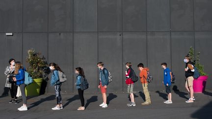 Des collégiens patientent devant leur&nbsp;établissement&nbsp;à&nbsp;Beaucamps-Ligny (Nord), le 2 juin 2020. (JULIE SEBADELHA / HANS LUCAS / AFP)