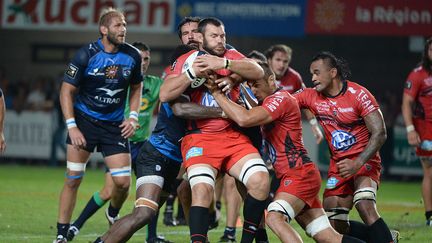 Le Toulonnais Daniel Rossouw est tacl&eacute; par le Montpelli&eacute;rain Jim Hamilton, le 16 ao&ucirc;t 2013, lors du premier match de la saison de Top 14. (BORIS HORVAT / AFP)