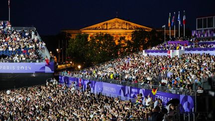 Des spectateurs à la place de la Concorde lors de la cérémonie d'ouverture des Jeux paralympiques 2024, à Paris. (DIMITAR DILKOFF / AFP)