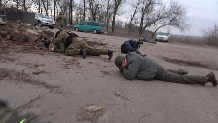 The Ukrainian Interior Minister (on the ground, on the left) is targeted by shellfire, on February 19, 2022, in Novoluhanske.  (STEPHANE GUILLEMOT / FRANCE TELEVISIONS)