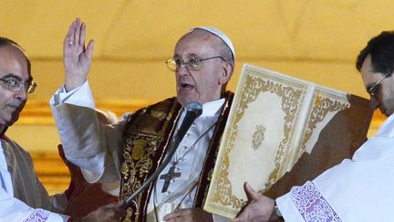 Le pape Fran&ccedil;ois b&eacute;nit la foule depuis le balcon de la basilique Saint-Pierre (Vatican) le 13 mars 2013. (VINCENZO PINTO / AFP)