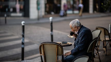 Un homme boit un café sur une terrasse enfin réouverte, le 2 juin 2020 à Paris. (MARTIN BUREAU / AFP)