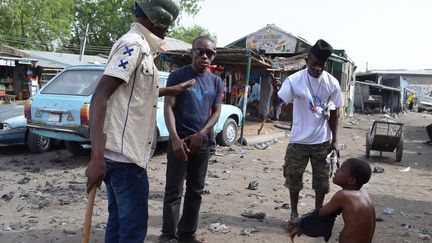 Des membres des milices civiles interrogent une personne suspect&eacute;e d'appartenir &agrave; Boko Haram, &agrave; Maiduguri, dans le nord du Nigeria. (AMINU ABUBAKAR / AFP)