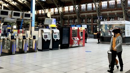 Un homme portant un masque traverse le hall quasi vide de la gare SNCF Lille Flandres, le 26 mars 2020. (AURÉLIEN ACCART / FRANCEINFO)