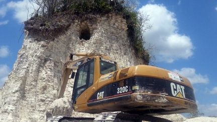 Au nord du Belize, le 10 mai 2013, une pelleteuse devant une ruine archéologique du site maya Noh Mul, détruite pour en faire des gravats afin de réparer des routes. (Jules Vasquez / AFP )