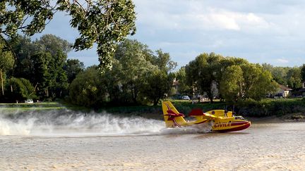 Les renforts sont venus des airs. Pour soutenir les sapeurs-pompiers au sol, quatre Canadair ont &eacute;t&eacute; mobilis&eacute;s. Un Canadair de la protection civile se ravitaille dans la Garonne &agrave; proximit&eacute; d&rsquo;habitations, &agrave; Cambes (Gironde). Les avions multiplieront les l&acirc;chers d&rsquo;eau au-dessus de la pin&egrave;de pendant quatre jours. (CYRIL GUITTON / CITIZENSIDE.COM)