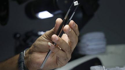 A man evaluates the quality of a cut diamond at a factory in Vladivostok, Russia, March 23, 2022. (YURI SMITYUK / TASS / SIPA USA)