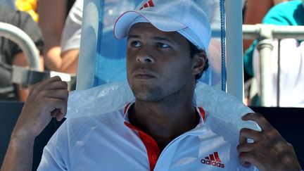 Jo-Wilfried Tsonga se repose, une poche de glace sur la nuque, lors de son match contre le Japonais Kei Nishikori, le 23 janvier 2012 &agrave; Melbourne (Australie). (PAUL CROCK / AFP)