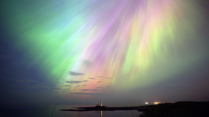 Une aurore boréale au-dessus du phare de St. Mary's, dans le nord-est de l'Angleterre, le 10 mai 2024. (OWEN HUMPHREYS / MAXPPP)