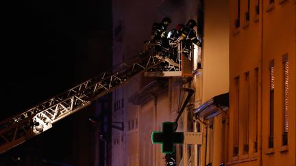 Des pompiers interviennent après une explosion suivie d'un incendie dans un immeuble de Lyon, le 9 février 2019. (ALEX MARTIN / AFP)