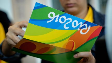 Une vendeuse de tickets pour les épreuves des jeux olympiques de Rio 2016, à Rio de Janeiro le 20 juin 2016. (YASUYOSHI CHIBA / AFP)