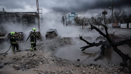 Firefighters work to put out a fire near a car dealership after a missile strike in kyiv, Ukraine, January 2, 2024. (OLEG PETRASYUK / MAXPPP)