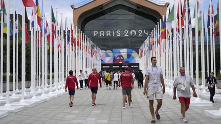 Des membres des délégations olympiques devant le restaurant du village olympique, à Saint-Denis (Seine-Saint-Denis), le 22 juillet 2024. (MICHEL EULER / POOL / AFP)