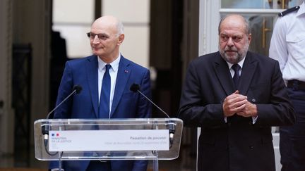 Passation de pouvoir entre l'ancien garde des Sceaux, Éric Dupond-Moretti, et le nouveau, Didier Migaud, lundi 23 septembre. (DIMITAR DILKOFF / AFP)