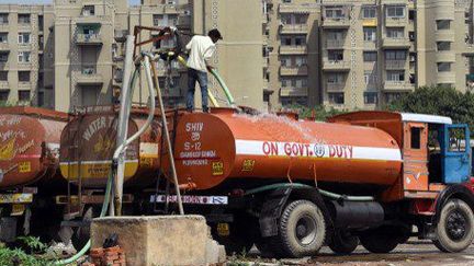 Un camion est rempli d'eau potable pompée dans un puits situé à New Delhi. (ROBERTO SCHMIDT / AFP)