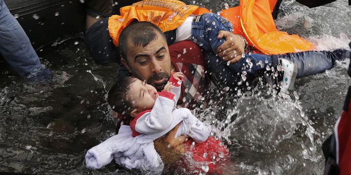 Un Syrien avec ses deux enfants tentant de débarquer après la traversée depuis la Turquie. Île de Lesbos, 24 septembre 2015.
 (Yannis Behrakis / Reuters)