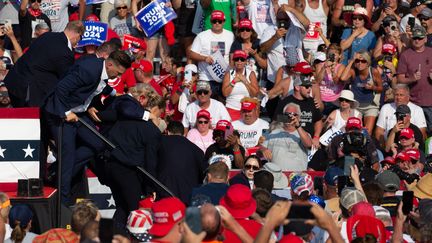 Donald Trump is evacuated from a rally in Pennsylvania after escaping an assassination attempt, July 13, 2024. (REBECCA DROKE / AFP)