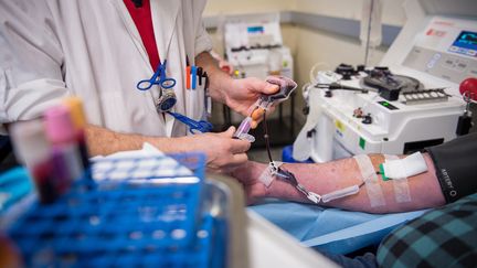 Une infirmière procède à une prise de sang. (GUILLAUME SOUVANT / AFP)