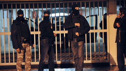 Des policiers postés devant le garage dans lequel les enquêteurs ont retrouvé&nbsp;du matériel explosif, des armes et des munitions, à Torcy (Seine-et-Marne), le 9 octobre 2012. (MEHDI FEDOUACH / AFP)