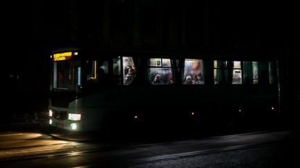 Un bus circule pendant une coupure de courant dans le centre-ville d'Odessa, en Ukraine, le 5 décembre 2022. (OLEKSANDR GIMANOV / AFP)