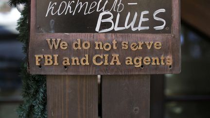 Une pancarte &agrave; l'ext&eacute;rieur d'un restaurant &agrave; Krasnaya Polyana (Russie)&nbsp;pr&eacute;cise qu'"ils ne servent pas les agents de la CIA et du FBI", le 7 f&eacute;vrier 2014. (JAE C. HONG / AP / SIPA)