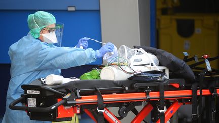 Une anesthésiste désinfecte du matériel médical qui a servi à amener six malades du coronavirus à l'hôpital de Brest, le 24 mars 2020. (JEAN-FRANCOIS MONIER / AFP)