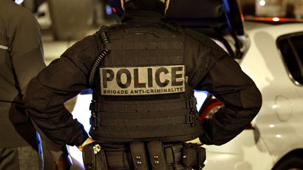 A French police officer from the anti-crime brigade, Brigade Anti-Criminalite de nuit (BAC N 75) is seen during a night patrol in Paris on October 16, 2020. (THOMAS COEX / AFP)