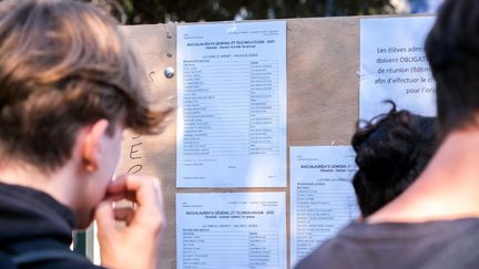 Des candidats au baccalauréat devant le panneau des résultats, à Valence (Drôme), le 5 juillet 2022. (NICOLAS GUYONNET / HANS LUCAS / AFP)