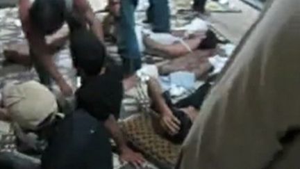 Des hommes tentent de venir en aide &agrave; des bless&eacute;s &agrave; Hama (Syrie), le 27 mai 2012 (capture d'&eacute;cran d'une vid&eacute;o post&eacute;e sur un r&eacute;seau social). (REUTERS)