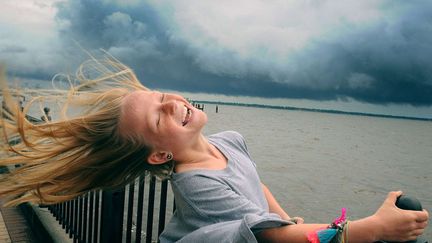 Une petite fille s'accroche &agrave; la balustrade apr&egrave;s le passage de la temp&ecirc;te tropicale Beryl &agrave; Ortega (Floride), le 28 mai 2012. (KELLY JORDAN / AP / SIPA)