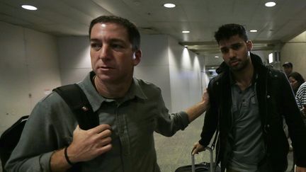 Glenn Greenwald,&nbsp;le journaliste du quotidien britannique "The Guardian" qui a publi&eacute; les r&eacute;v&eacute;lations d'Edward Snowden,&nbsp;et son compagnon&nbsp;David Miranda, le 19 ao&ucirc;t 2013 &agrave; l'a&eacute;roport international de Rio de Janeiro (Br&eacute;sil). (RICARDO MORAES / REUTERS)