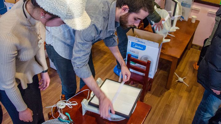 Lors des ateliers qu'elle organise, l'&eacute;quipe de Smart Air Filters explique comment fabriquer un filtre &agrave; air low cost. (THOMAS BAIETTO / FRANCETV INFO)