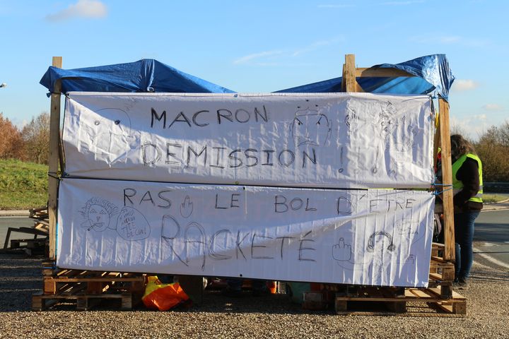 Des slogans anti-Macron, écrits par les "gilets jaunes" à l'arrière de leur abri sur le rond-point d'Albert (Somme), le 4 décembre 2018. (BENOIT ZAGDOUN / FRANCEINFO)