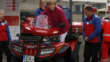 La chanceli&egrave;re allemande Angela Merkel essaie un v&eacute;hicule destin&eacute; aux sauvetages en montagne lors d'une visite de la protection civile &agrave; Bonn (Allemagne), le 19 ao&ucirc;t 2014. (INA FASSBENDER / REUTERS)