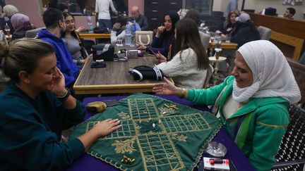 Des femmes dans un café de la ville de Homs, en Syrie, le 13 décembre 2024. (AAREF WATAD / AFP)