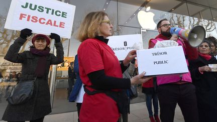 Des activistes de l'association Attac manifestent dans un Appel Store, à Aix-en-Provence, le 30 janvier 2019. (BORIS HORVAT / AFP)