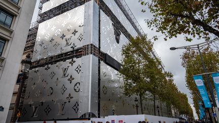 La façade du futur bâtiment Louis Vuitton sur les Champs-Élysées (Paris) recouverte d'une bâche avec le logo de la marque, le 3 novembre 2023. (BERTRAND GUAY / AFP)