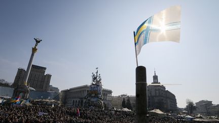 Un drapeau de la marine ukrainienne flotte au dessus d'un rassemblement antiguerre, sur la place Ma&iuml;dan, &agrave; Kiev (Ukraine), le 23 mars 2014. (GLEB GARANICH / REUTERS)