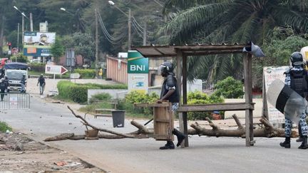 Des policiers démantèlent un barrage dressé par des étudiants à Abidjan, le 13 septembre 2017. Les jeunes protestent contre l'augmentation des droits universitaires. (ISSOUF SANOGO / AFP)